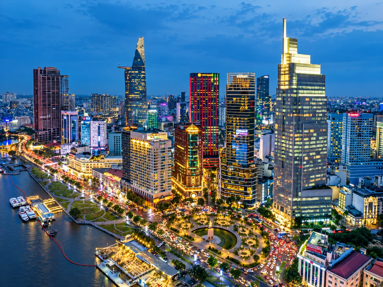 Ho Chi Minh City skyline and riverfront illuminated at dusk