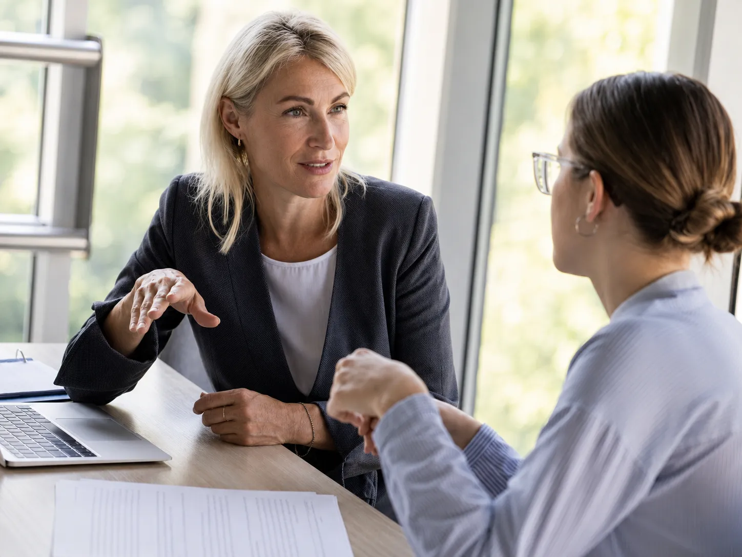 Two professionals discussing documents during a consultation