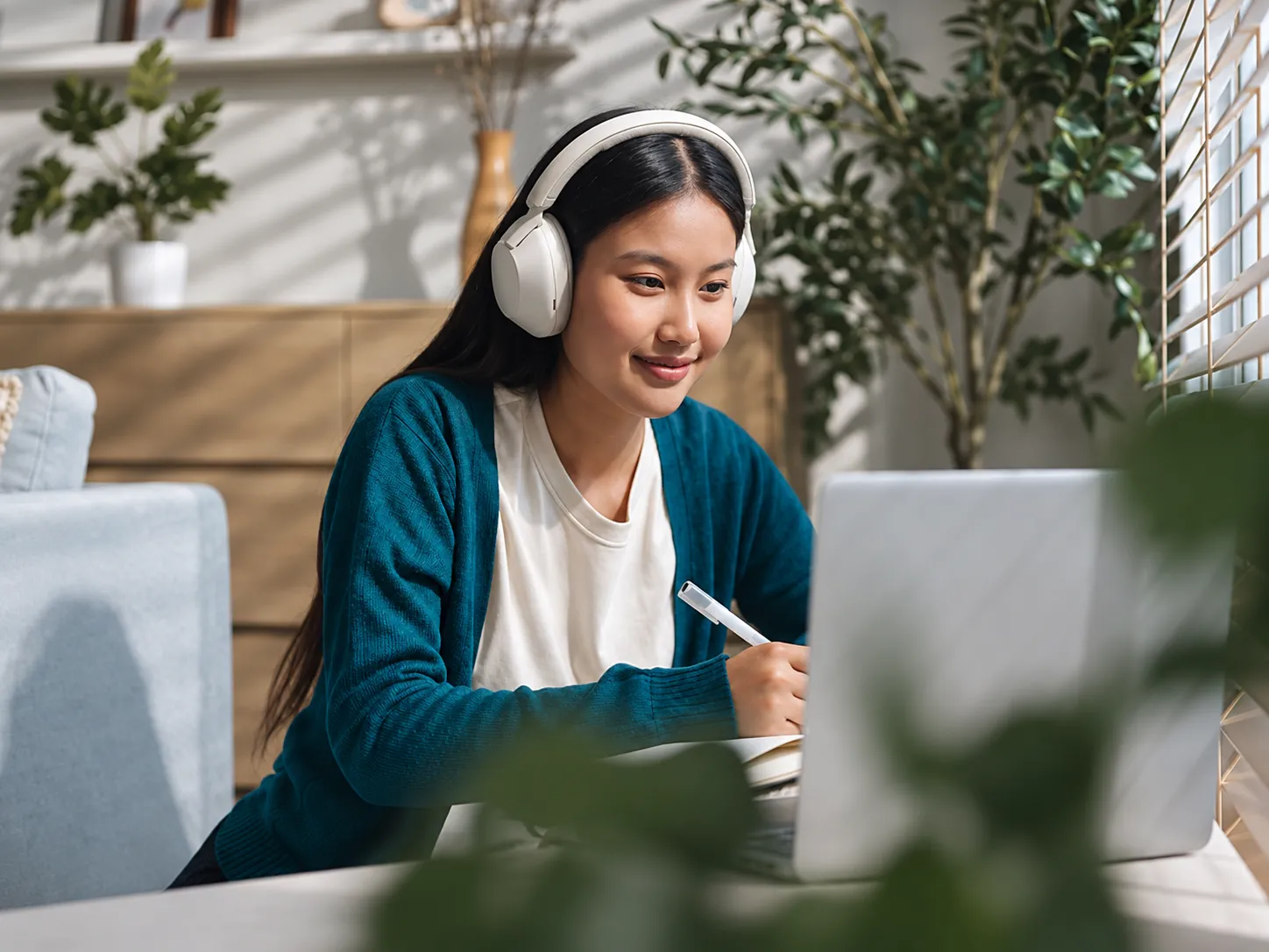 A professional wearing a headset while working at a laptop