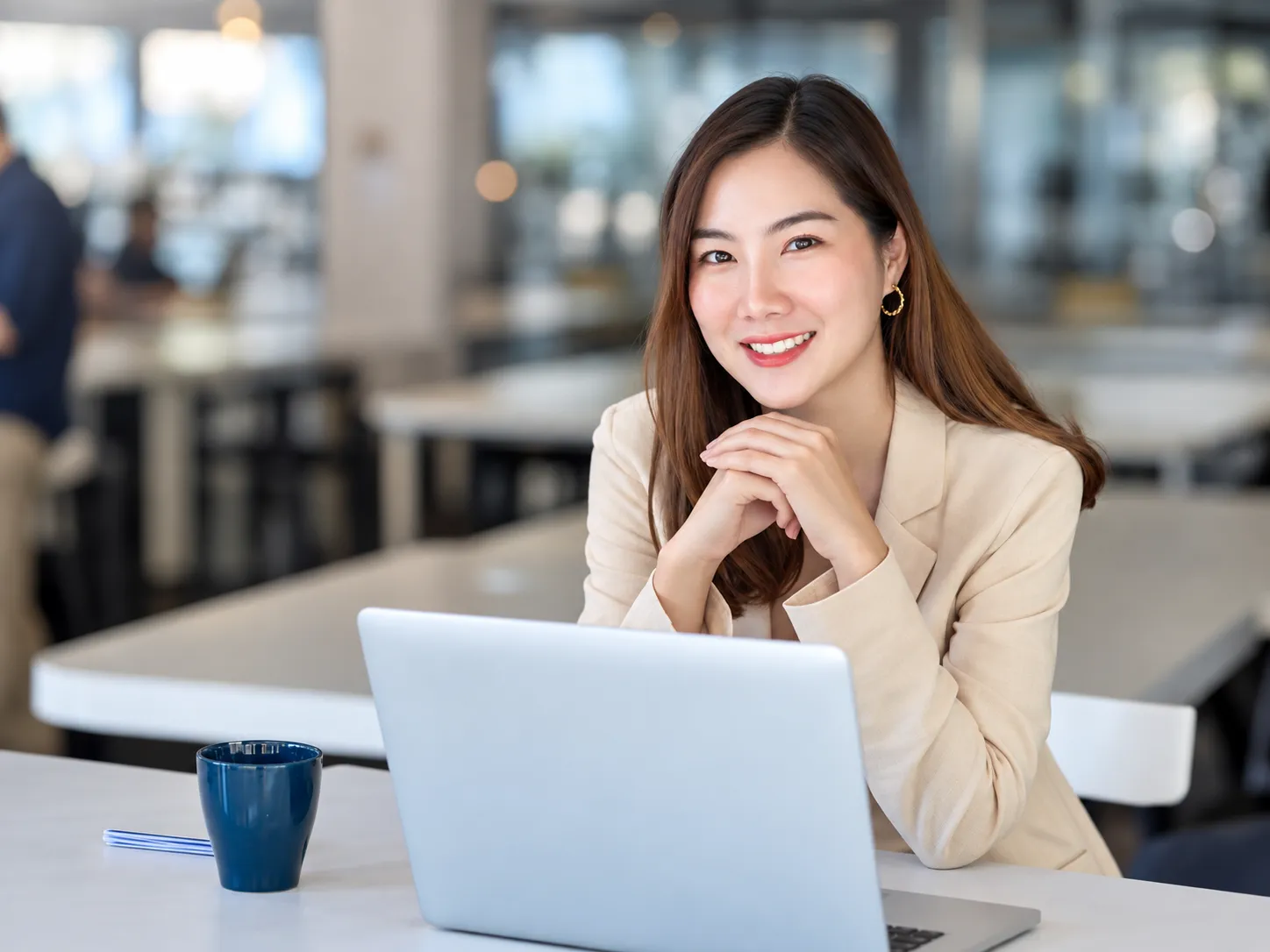 Professional seated at a desk with a laptop